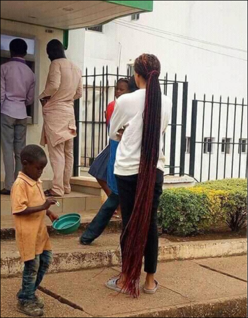 Oga ju!! Fashion Or Madness? Girl With A Floor-length Braid Spotted At A Bank In Jos